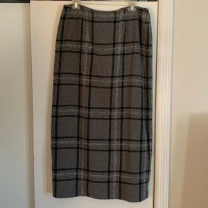 Black, gray and white, wool mid length skirt. Zip up back with back slit/vent.
